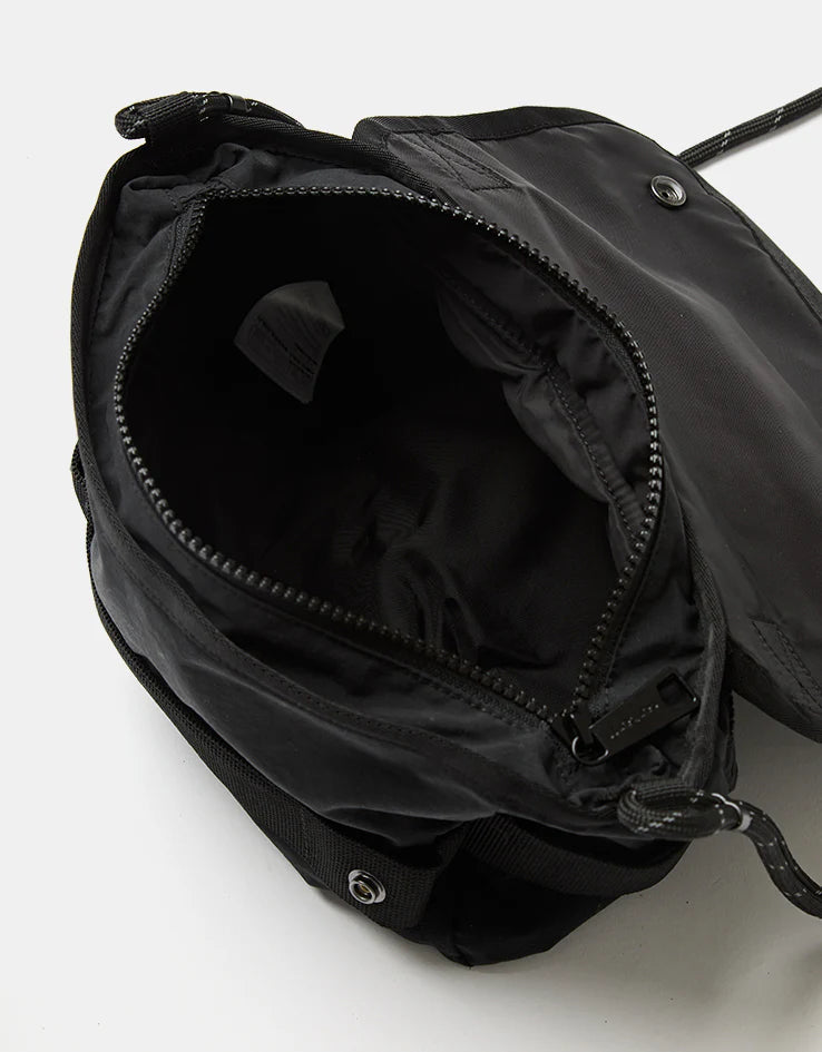 Black shoulder bag with open top, zip closure, visible interior lining and stitching
