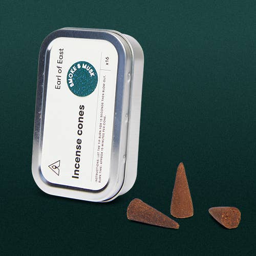 Incense cones with packaging on a dark green background