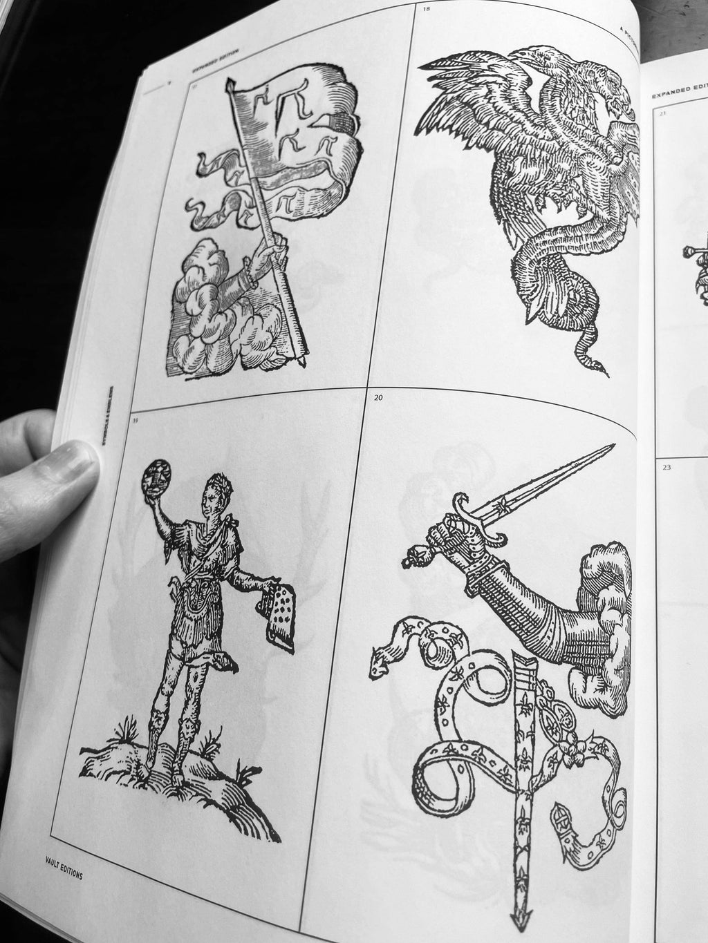 Open book page spread with eagle, sword, knight figure, and carved ornament drawings