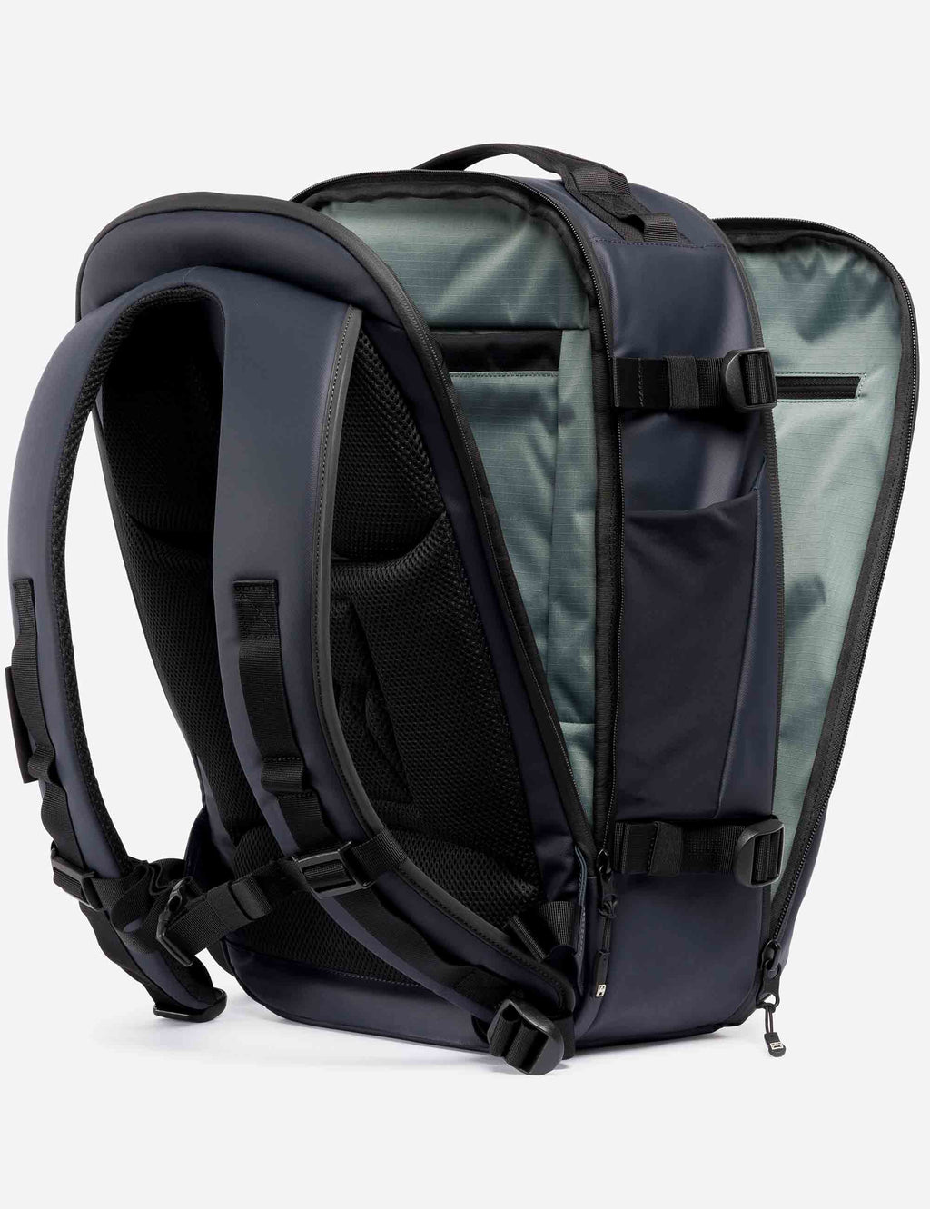 Midnight blue hybrid backpack opened to show padded laptop sleeve and mesh pocket