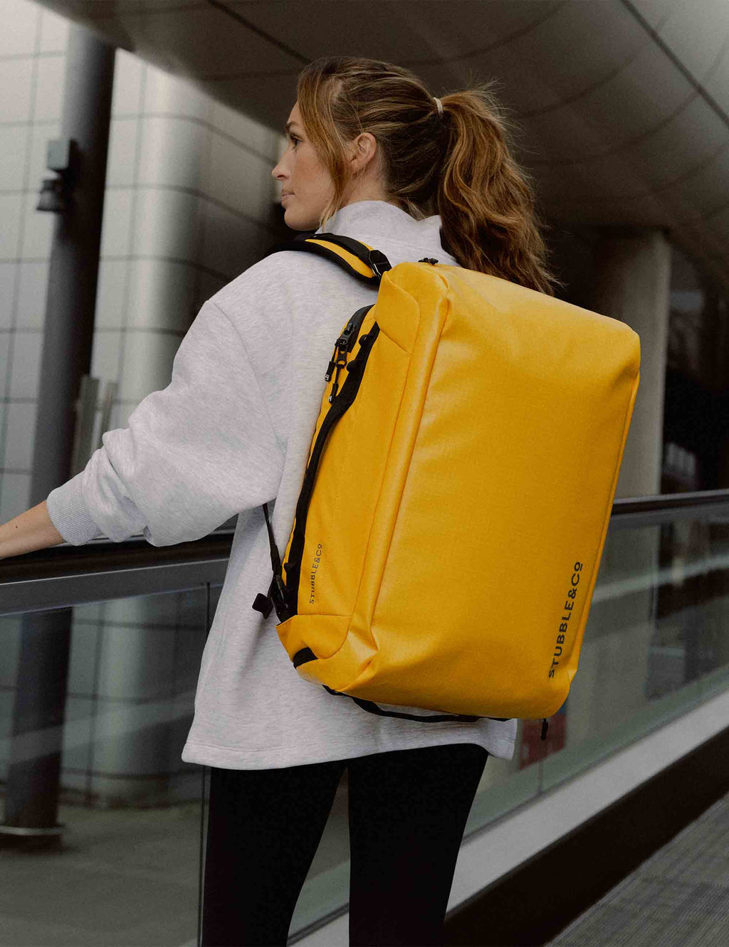 Yellow 30L kit bag worn on back with carry handle and shoulder straps