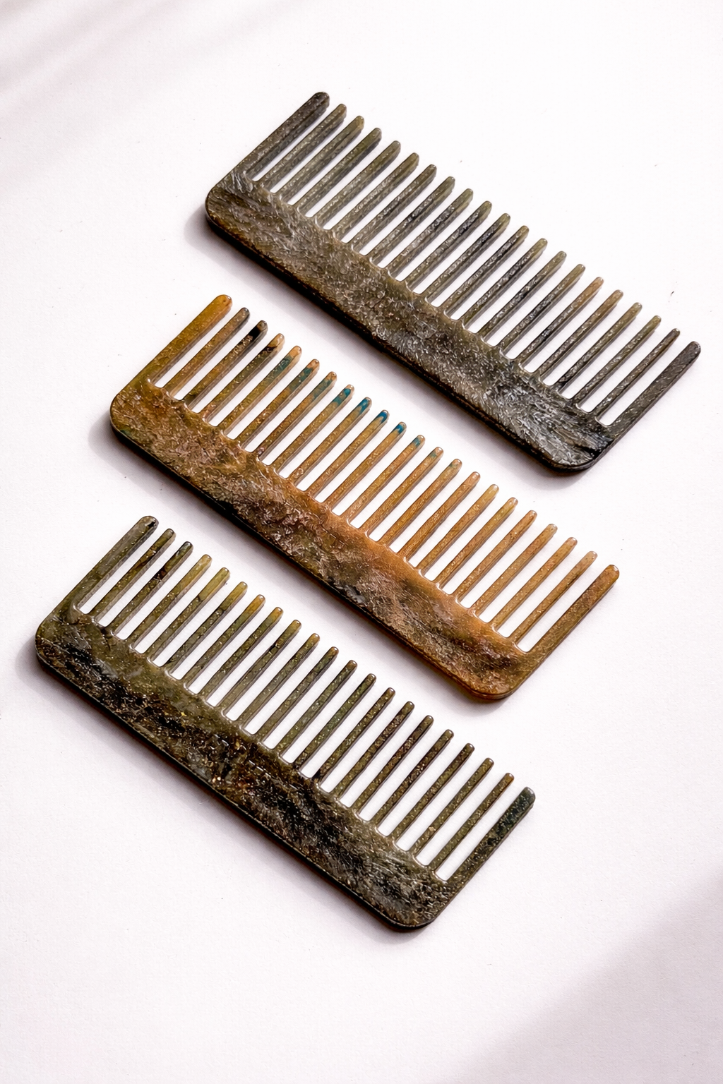 Recycled plastic hair comb set, dark and tan, evenly spaced teeth.