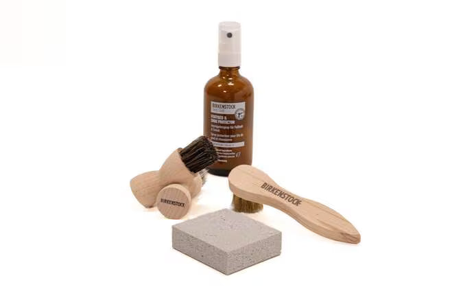 Suede leather care kit with bottle, brush, sponge and cloth