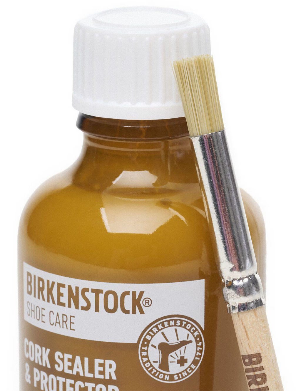 Amber cork sealer bottle with cap and included brush applicator, close-up view