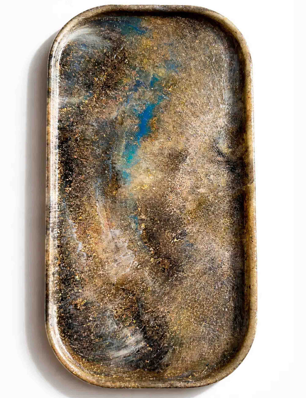 Recycled plastic tray, rounded rectangular bowl, speckled bronze with blue and white specks.