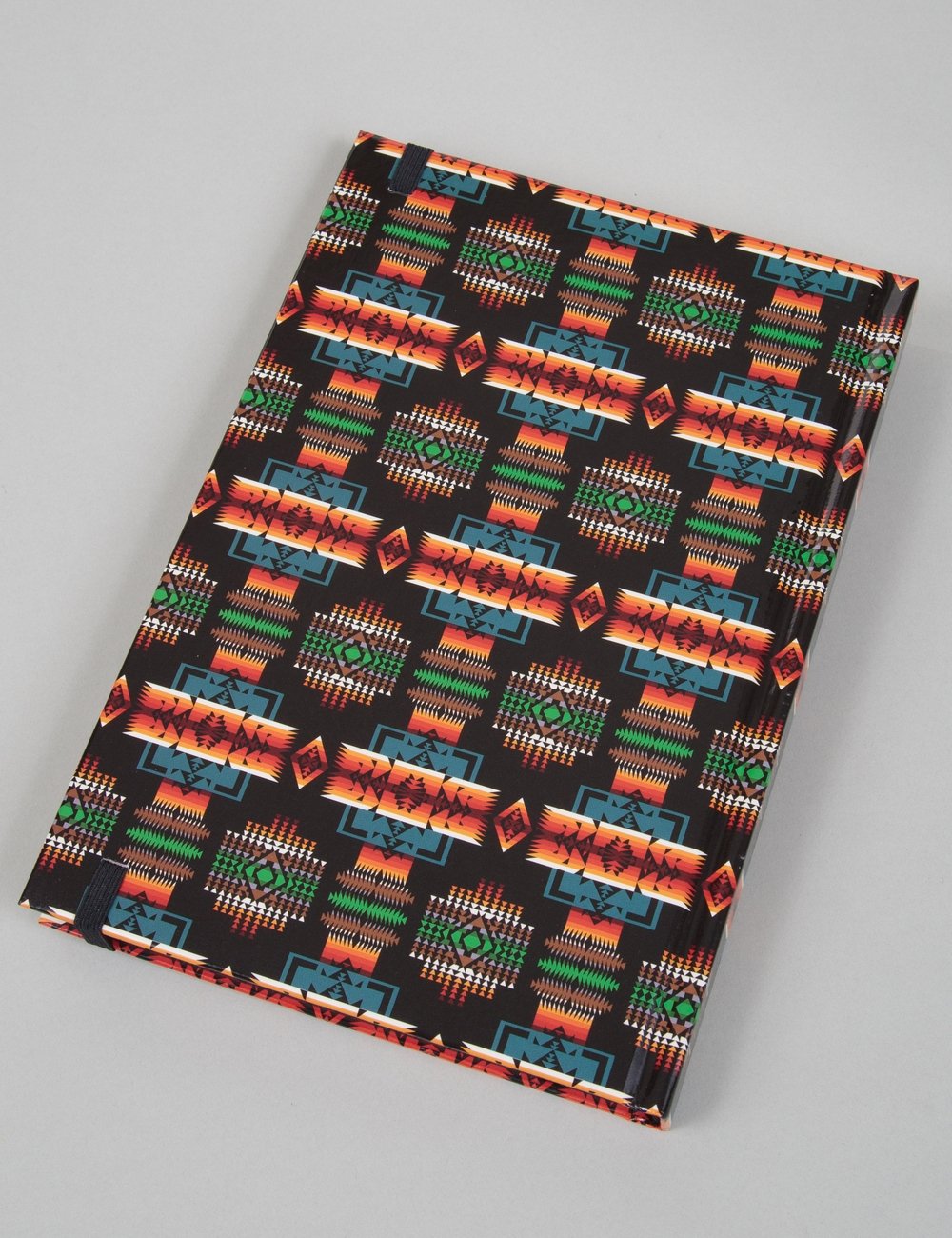 Lined notebook with black cover featuring colorful geometric motif design