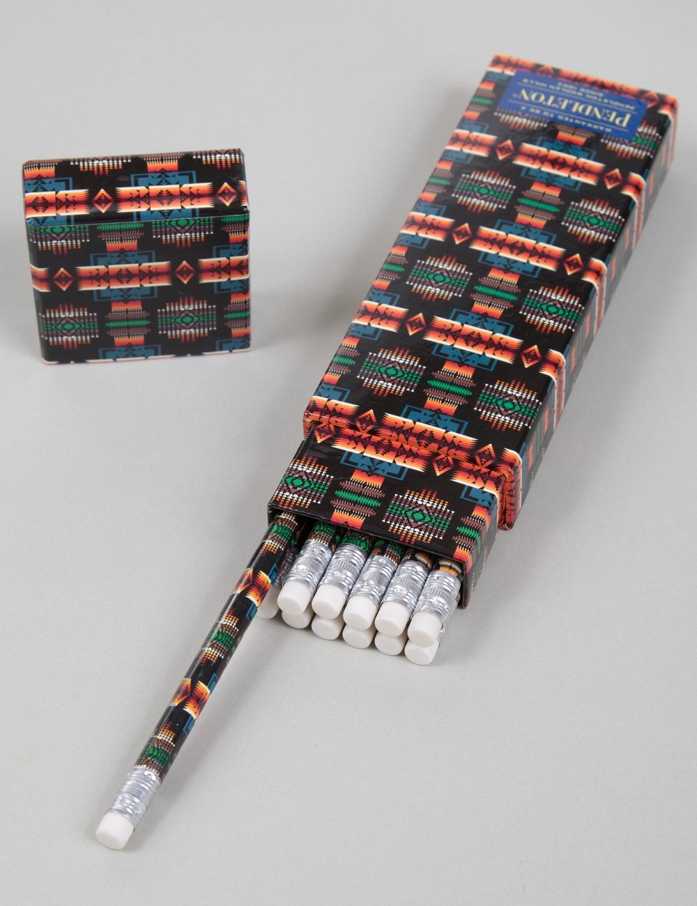 Printed pencil roll case with geometric pattern and white pencils, black base