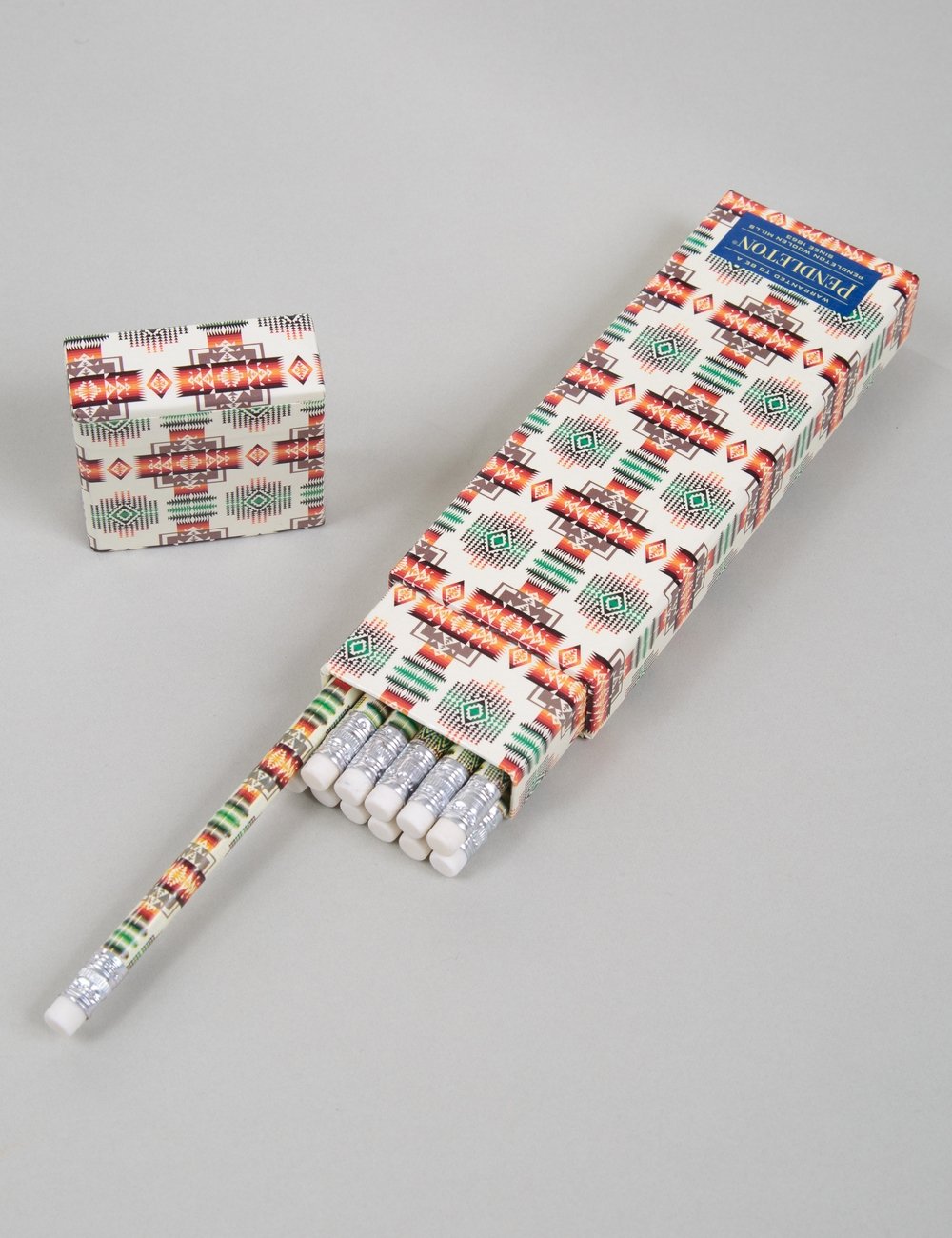 Printed 12-pencil set with white patterned wrap; pencils aligned with caps visible