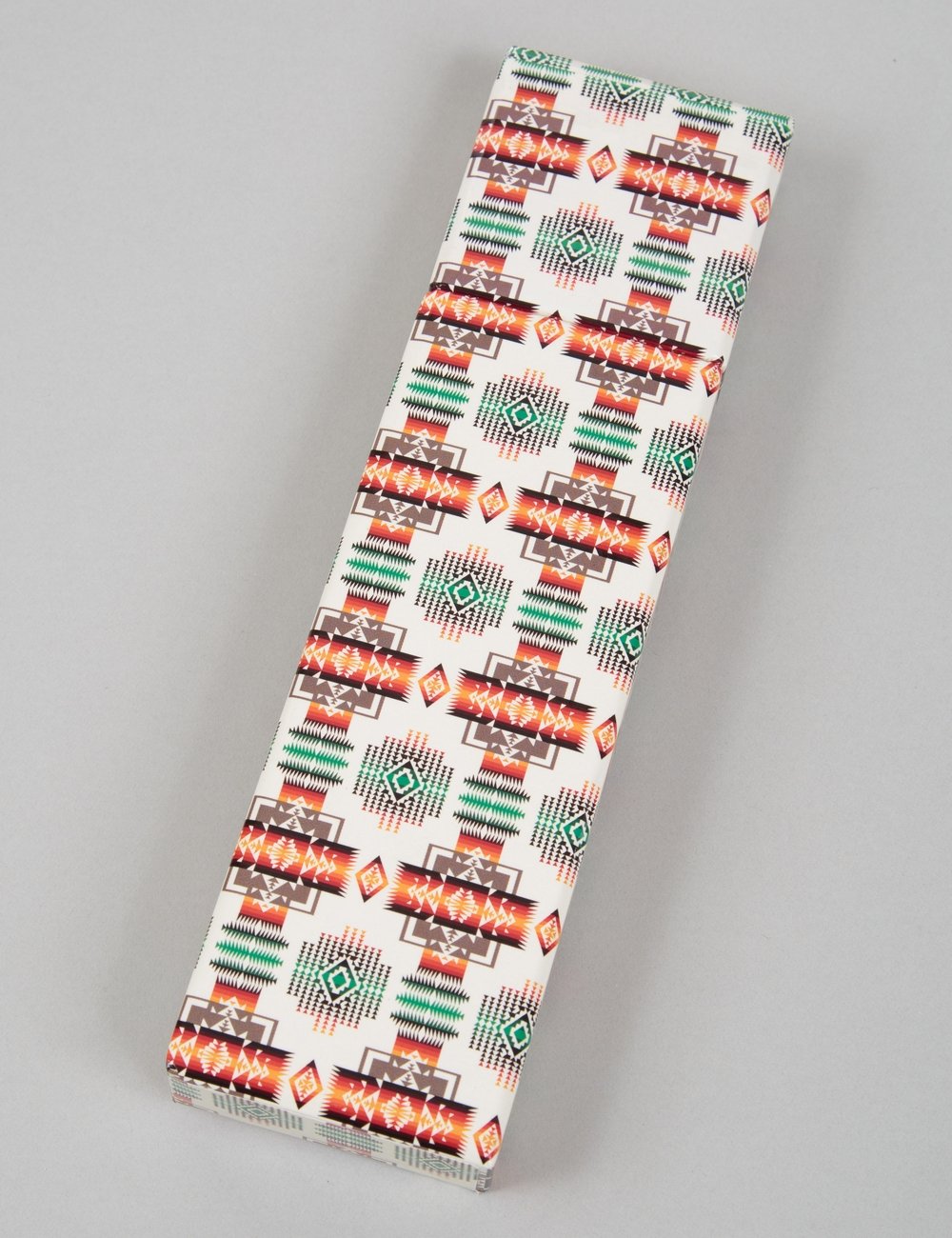 Printed 12-pencil set sleeve, white with green and orange geometric icons; pencils enclosed