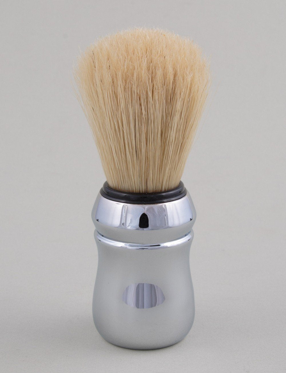Shaving brush with beige bristles and reflective chrome handle, round base