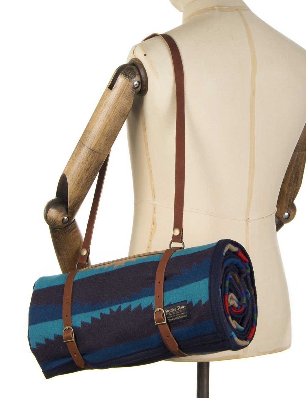 Rolled jacquard robe in blue-teal carrier with brown leather handle straps
