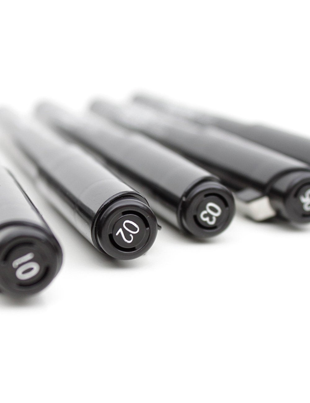 Close-up of black fineliner pens with numbered tip sizes 70 and 40 on caps