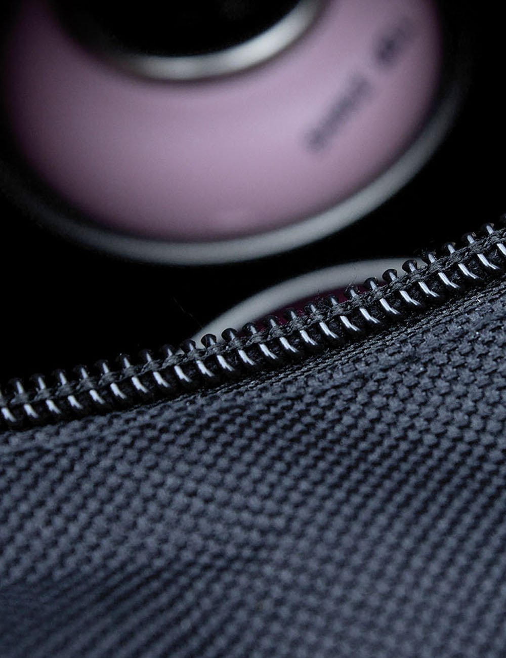 Black nylon bag zipper track and close-up stitching on fabric