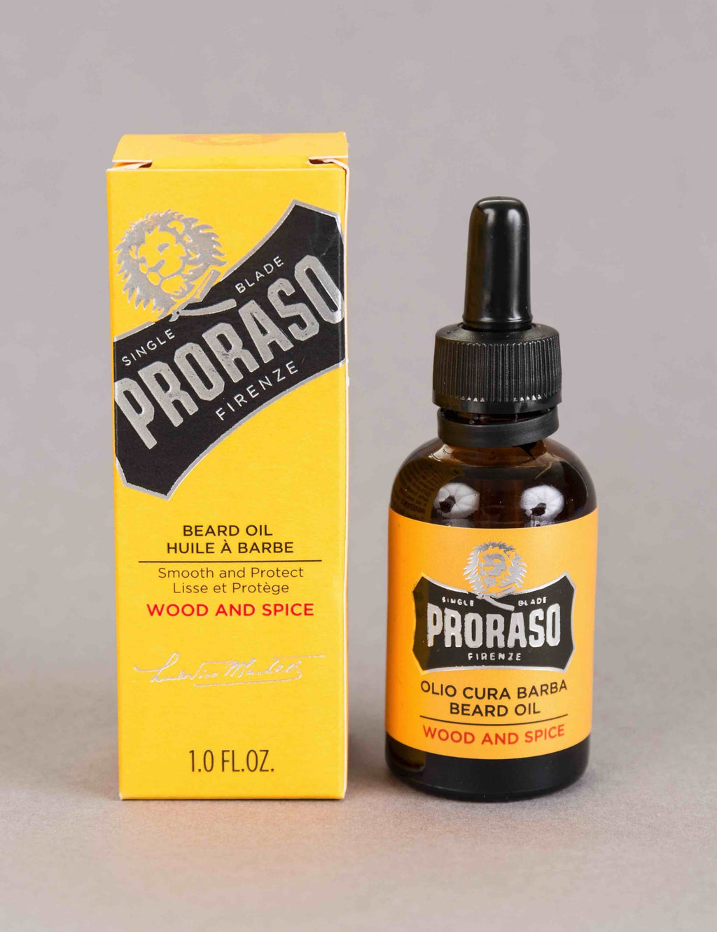 Beard oil bottle beside retail box, black cap dropper, Wood & Spice aroma