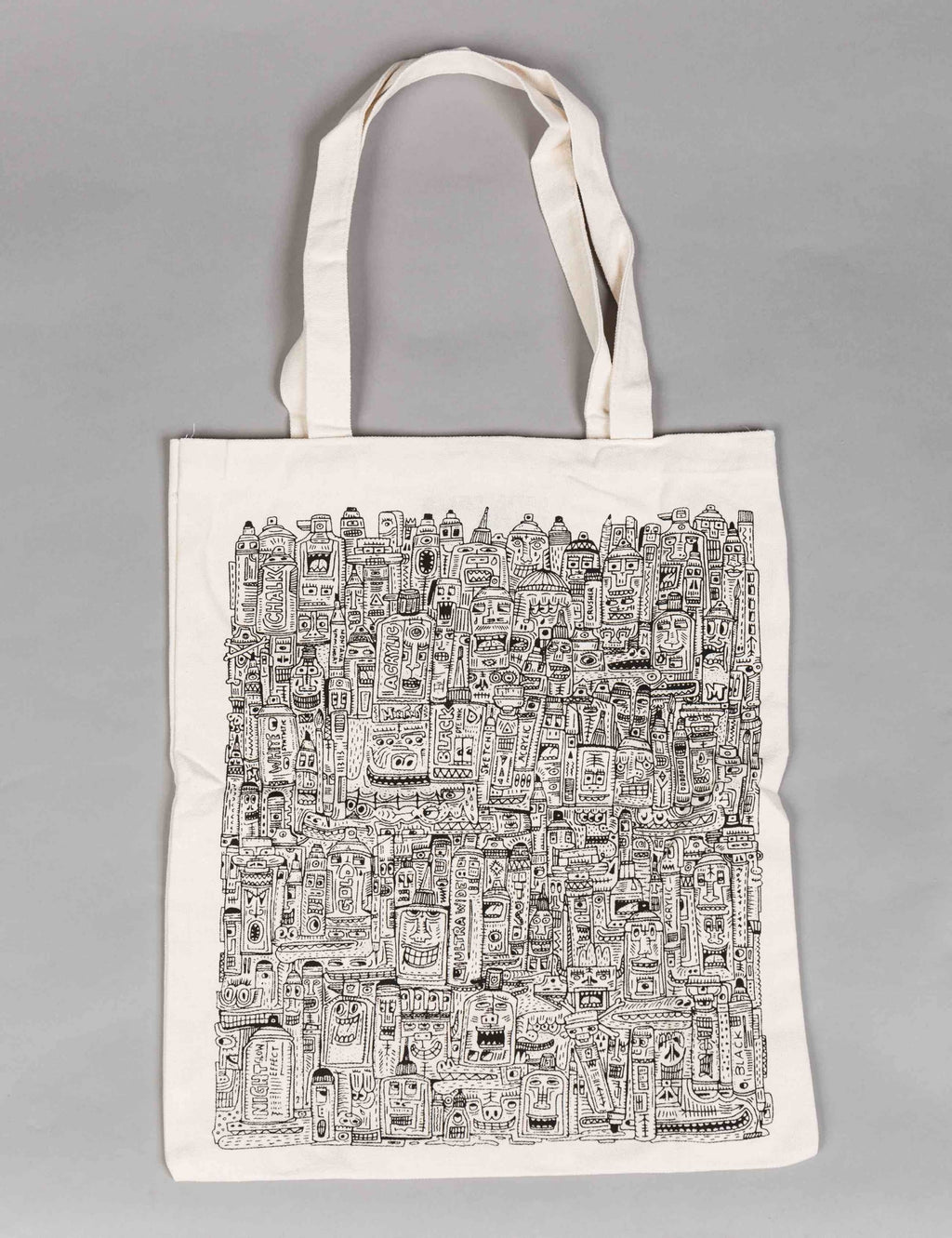 Natural canvas tote bag front view with detailed city block print and short handles