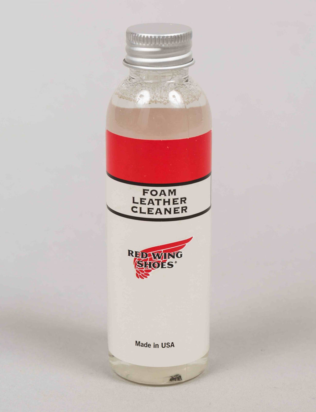 Foam leather cleaner bottle with red label and black cap, Red Wing Shoes.