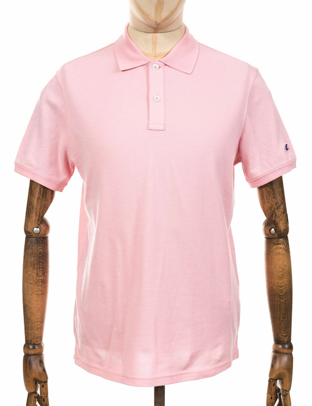Pink polo shirt with button placket, fold-over collar, and short sleeves