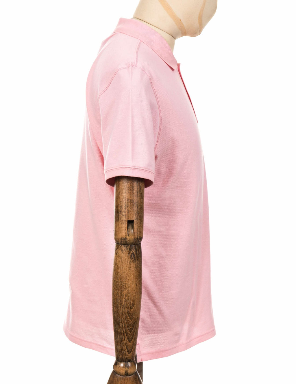 Pink polo shirt side view with short sleeves and straight hemline
