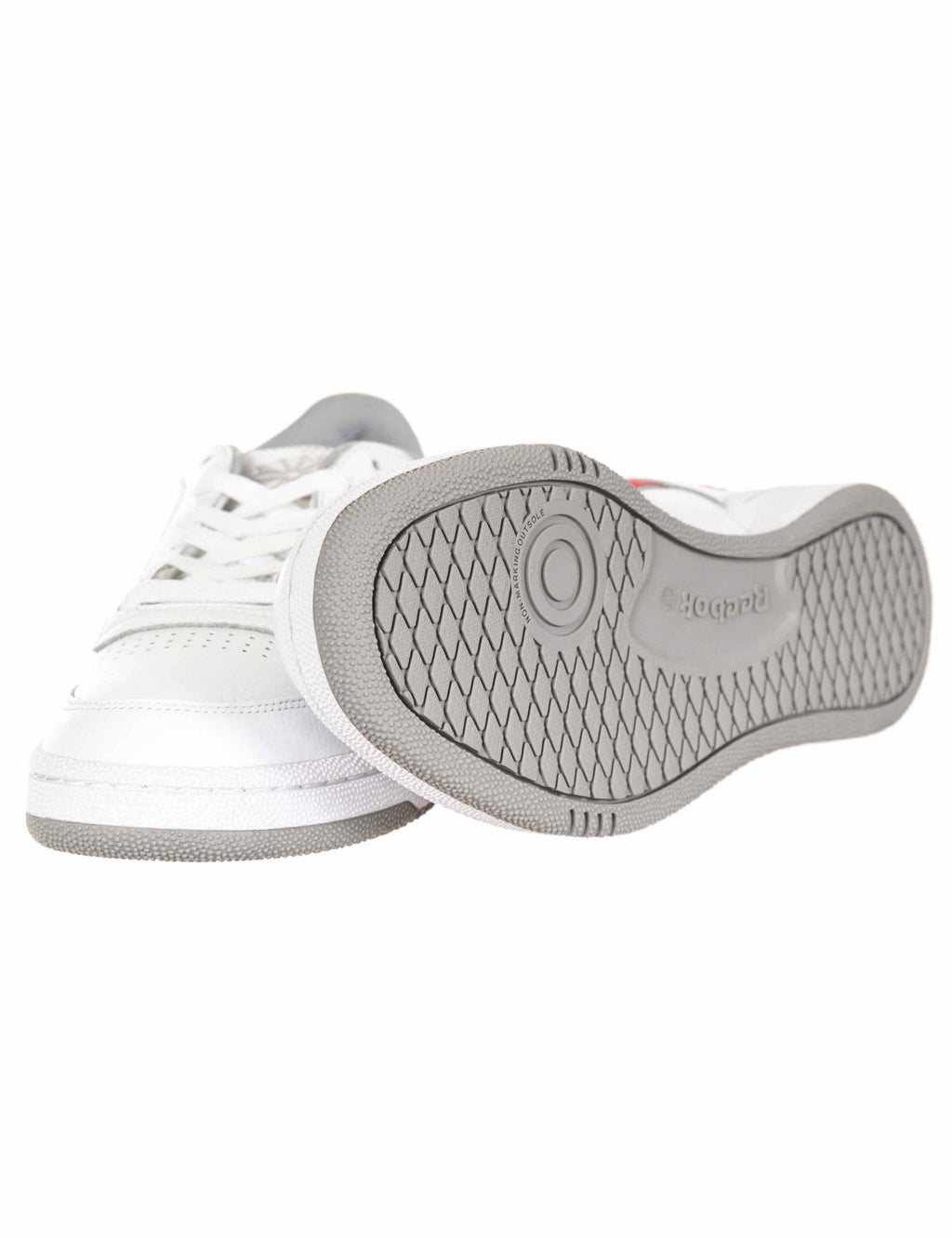 White trainers with textured gray rubber outsole and cushioned insole