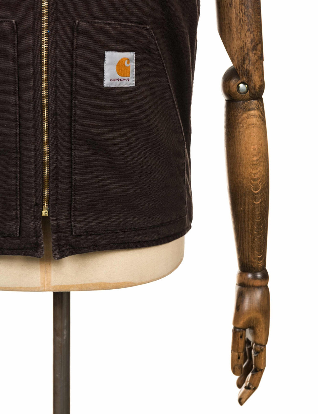 Dark brown vest front close-up with zip, chest pocket, and Carhartt logo patch
