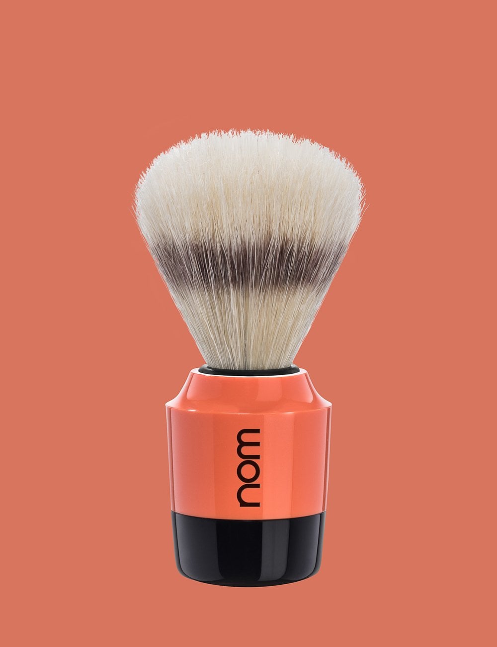 Shaving brush with rounded white bristle head, coral handle, and black collar