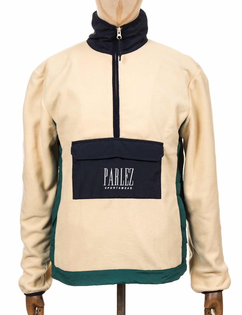 Cream fleece zip-up top with navy hood and front logo patch