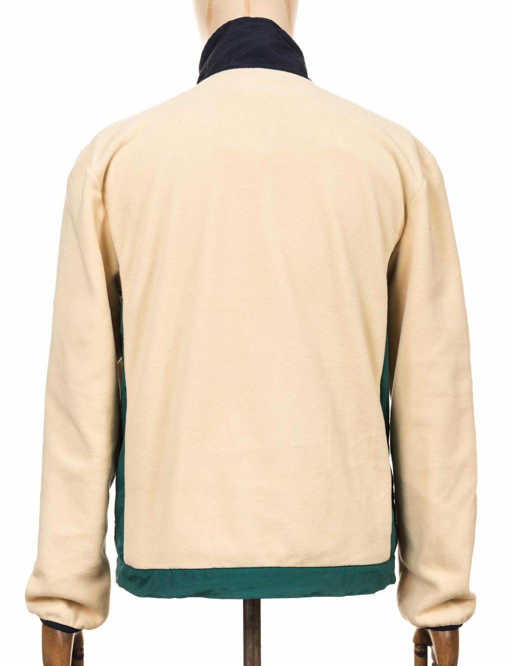 Cream fleece zip-up top with contrast navy collar and teal hem