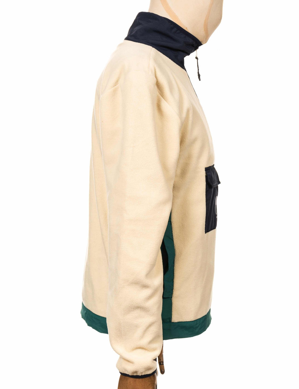 Cream fleece zip-up top with navy hood and teal trim at cuffs and hem