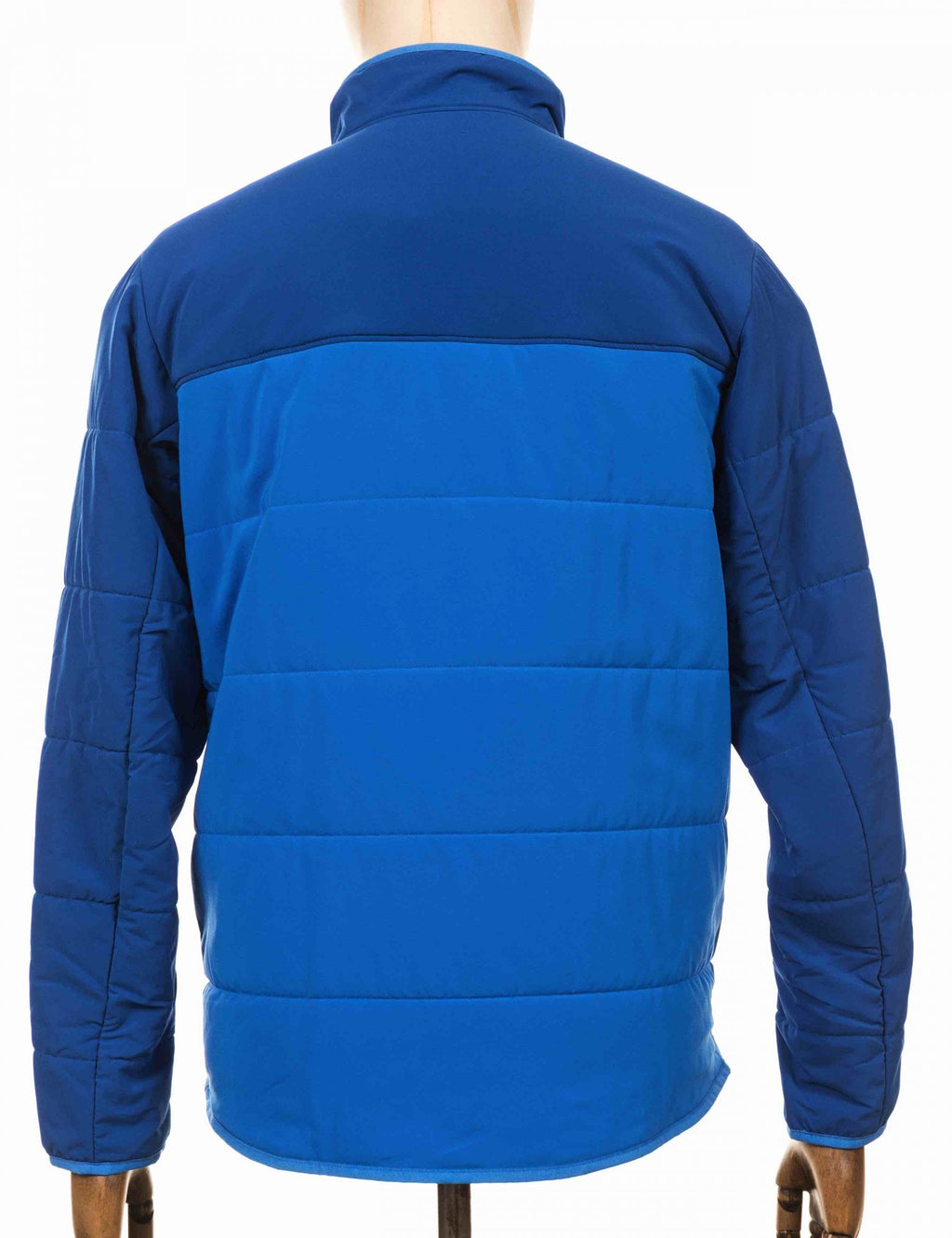 Back view of packable blue puffer jacket with full-zip and quilted panels