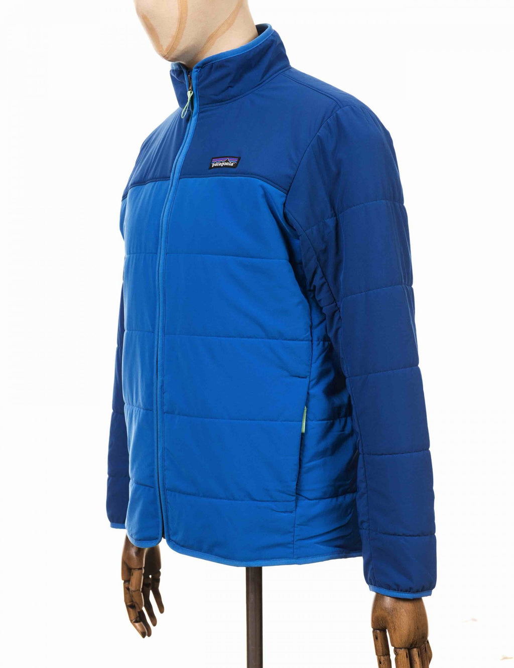 Blue packable puffer jacket with full-zip, quilted front, and logo patch
