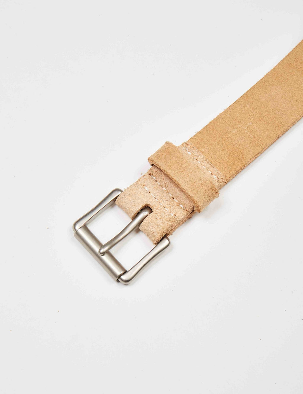 Suede leather belt strap end with silver-tone buckle and stitched keeper, tan.
