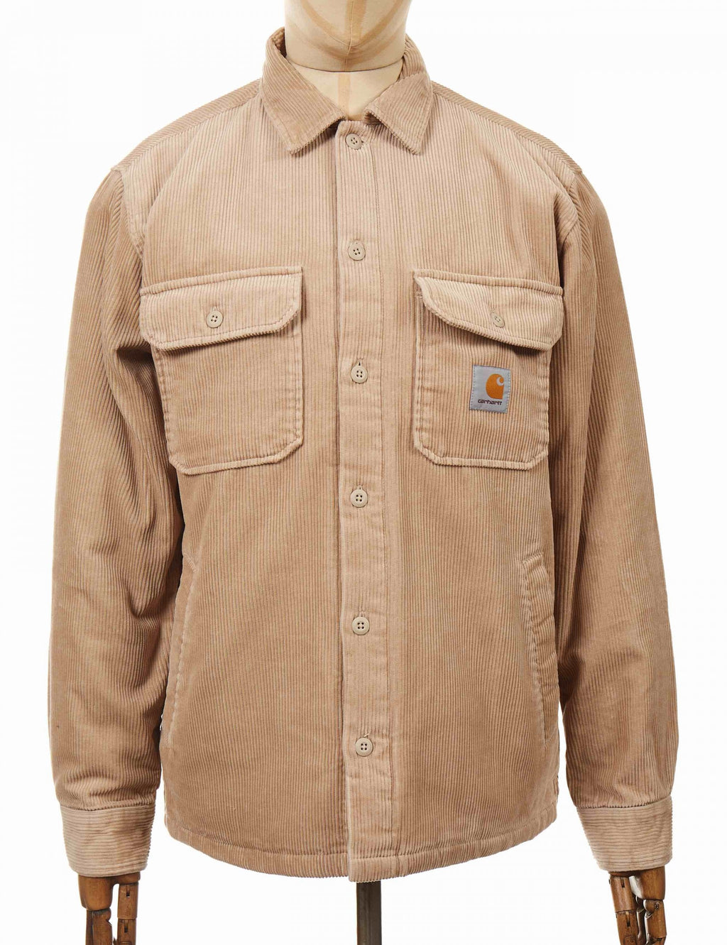 Tan shirt jacket with button front, two chest flap pockets, logo patch on left chest.