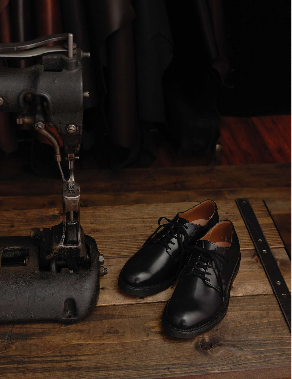 Black leather oxford work shoes displayed with lace-up front and rubber sole.