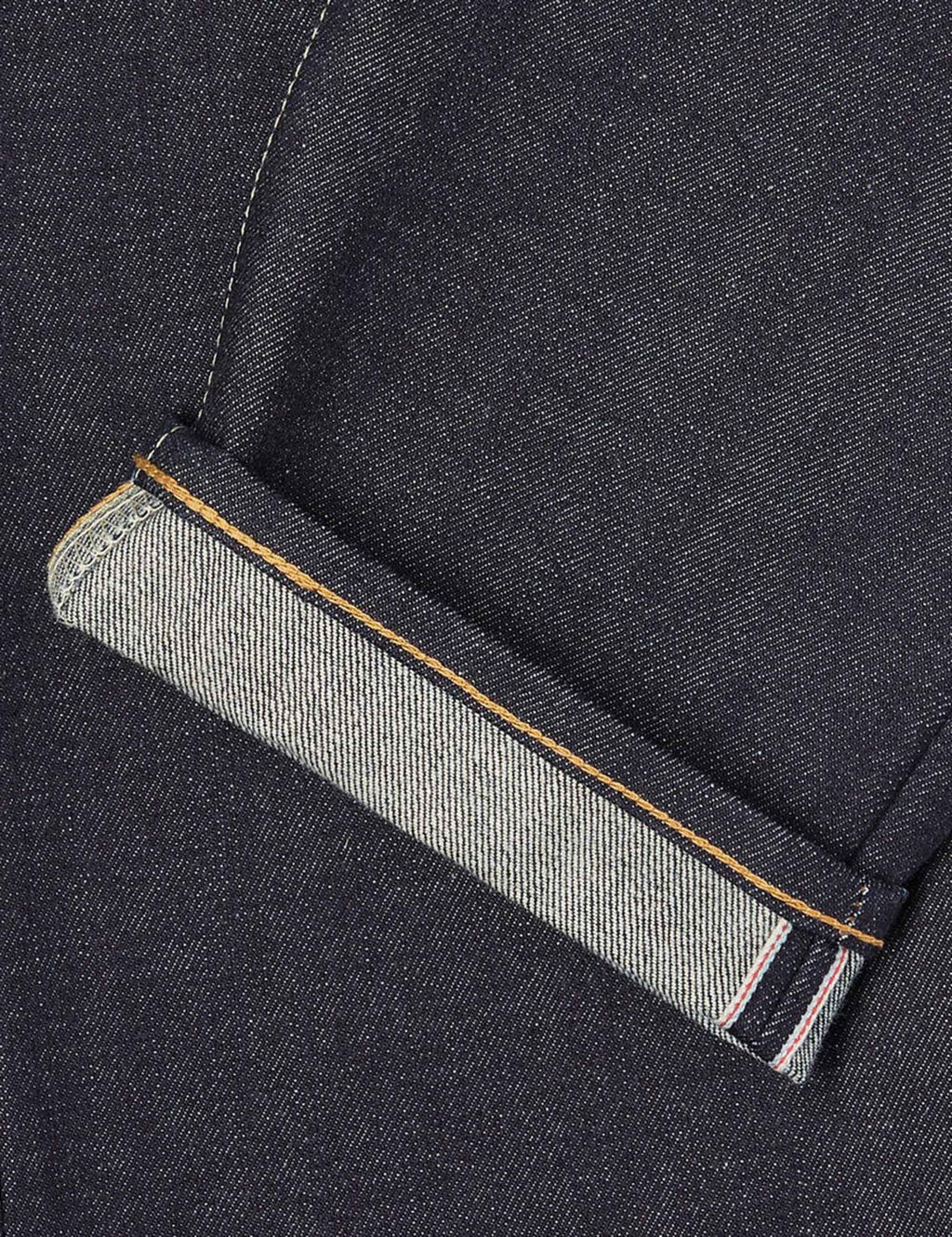 Jeans coin pocket with selvedge fabric trim and angled pocket edge, dark indigo denim