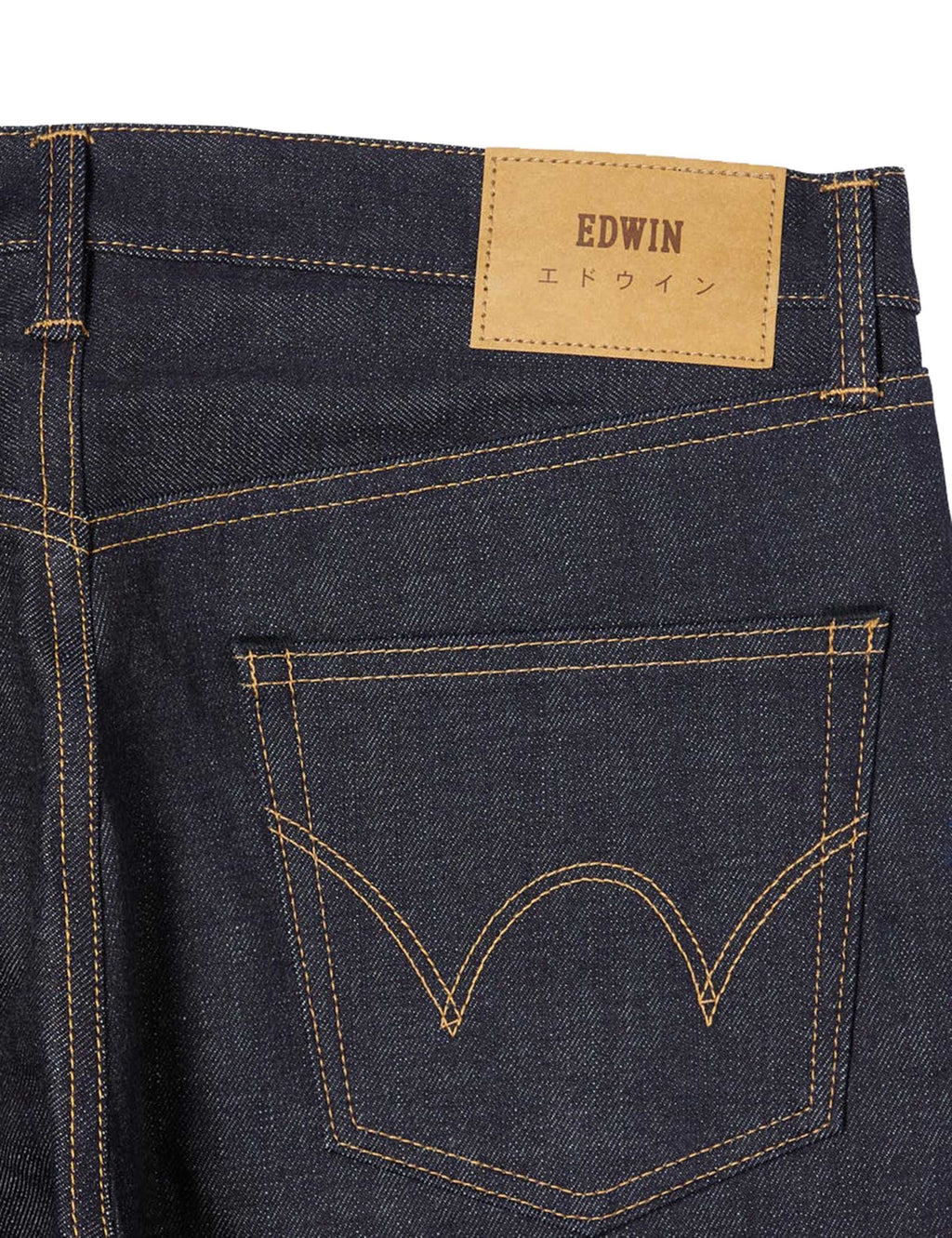 Dark blue jeans back pocket with yellow selvedge stitching and brand leather patch