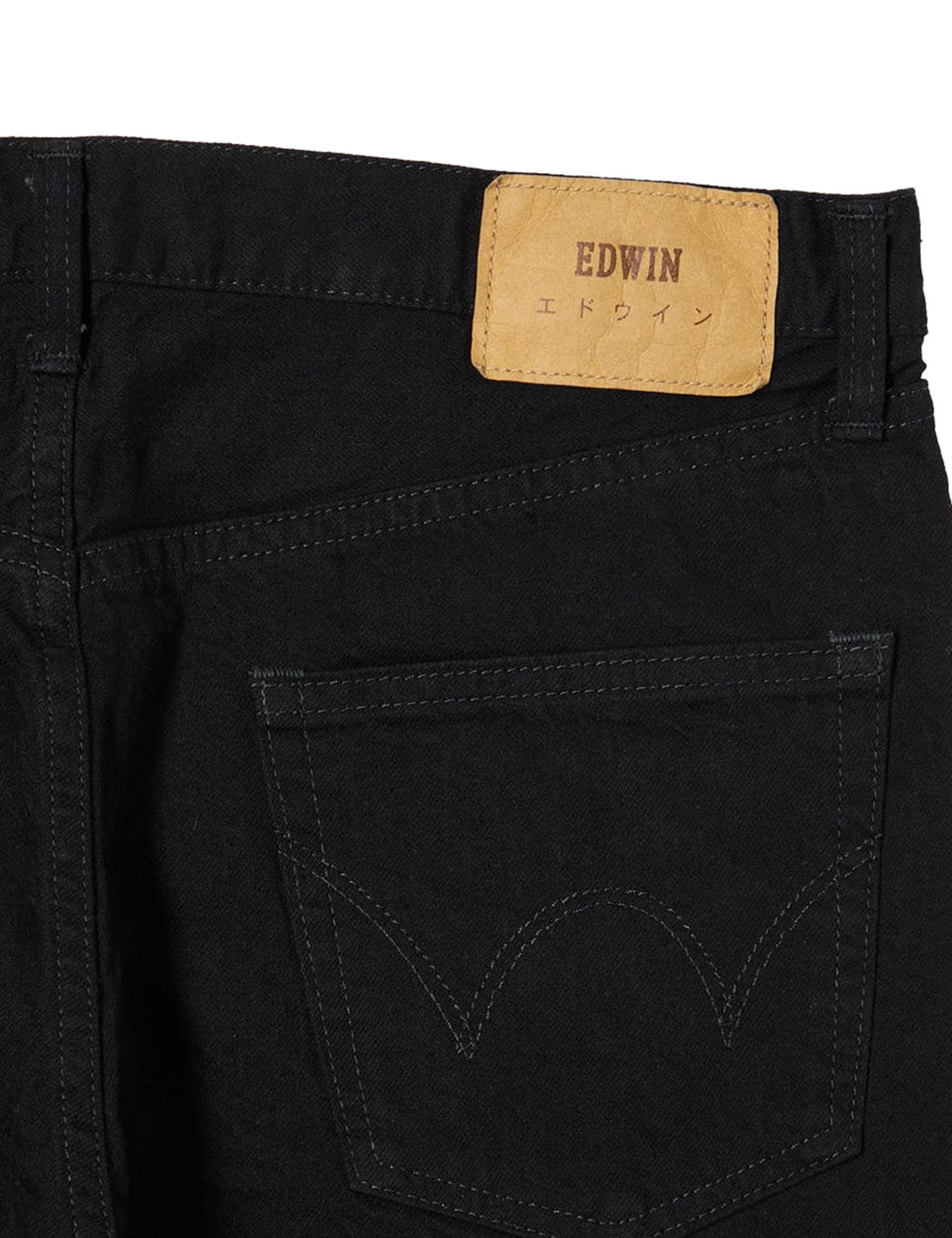 Black denim jeans close-up of EDWIN logo patch and front pocket stitching