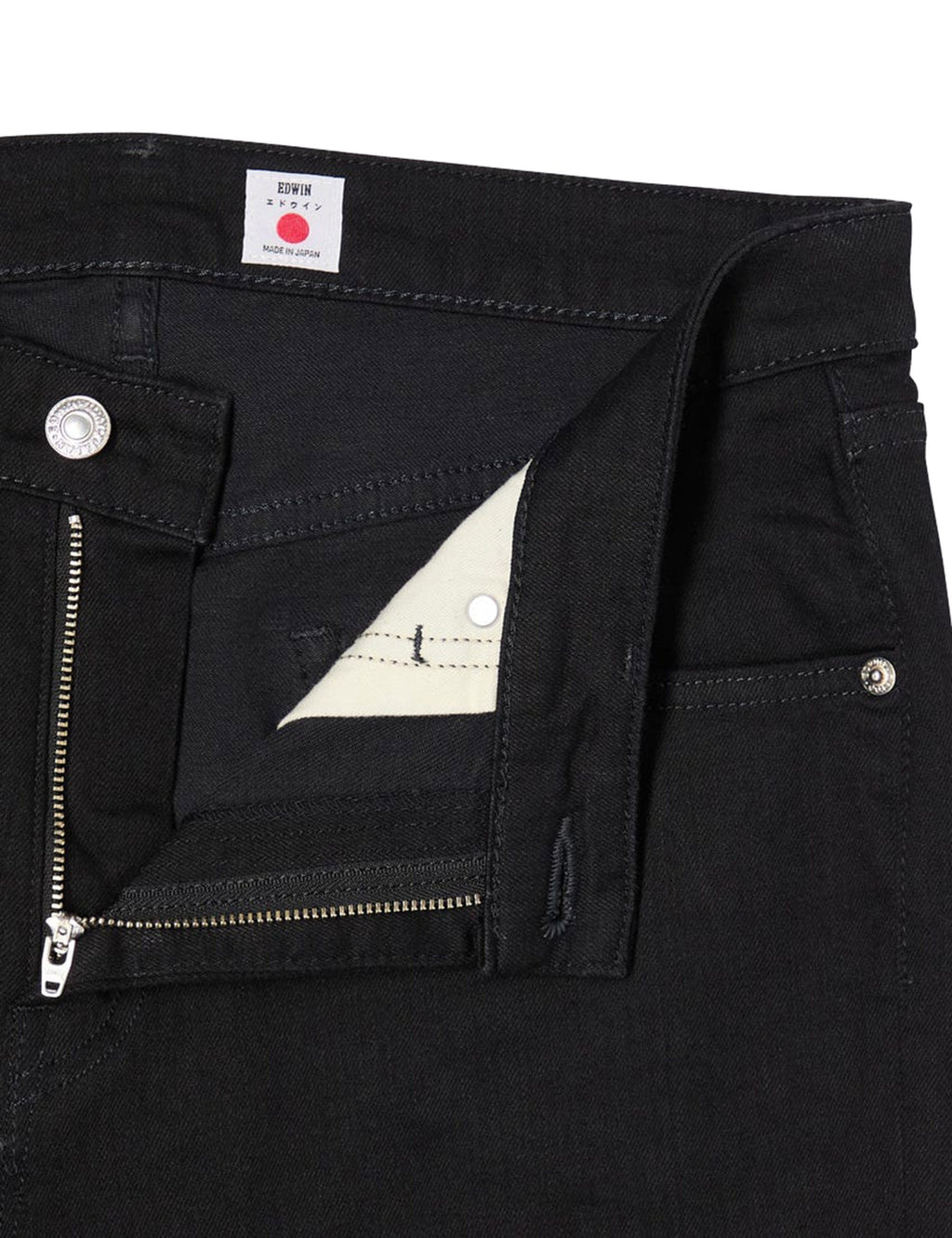 Black skinny jeans front with zipper fly, logo patch, and angled side pocket