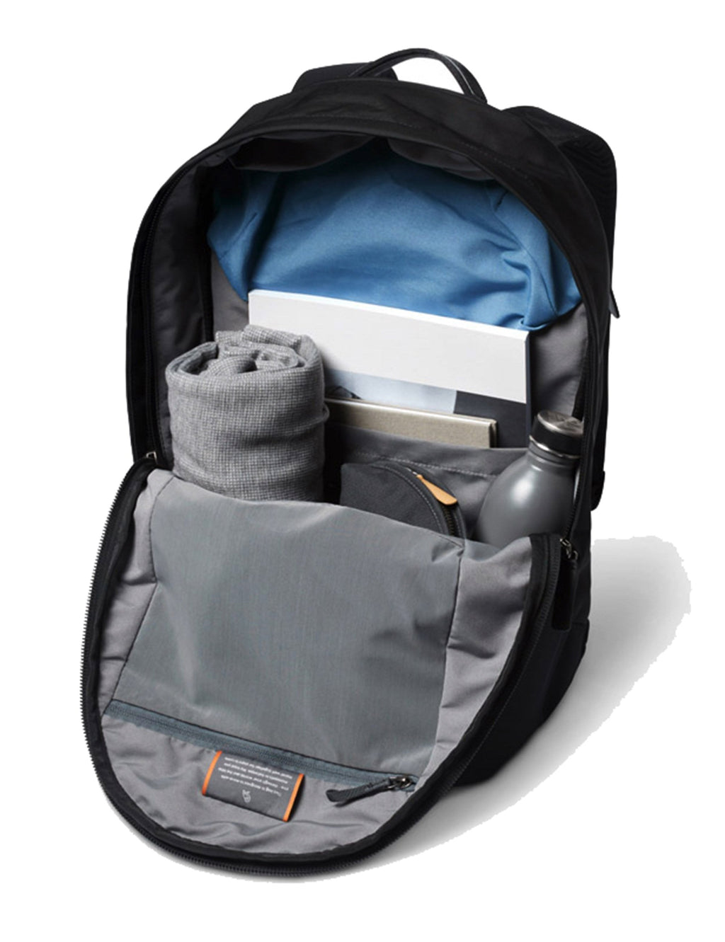 Black compact backpack open with blue-lined main compartment and gray organizer