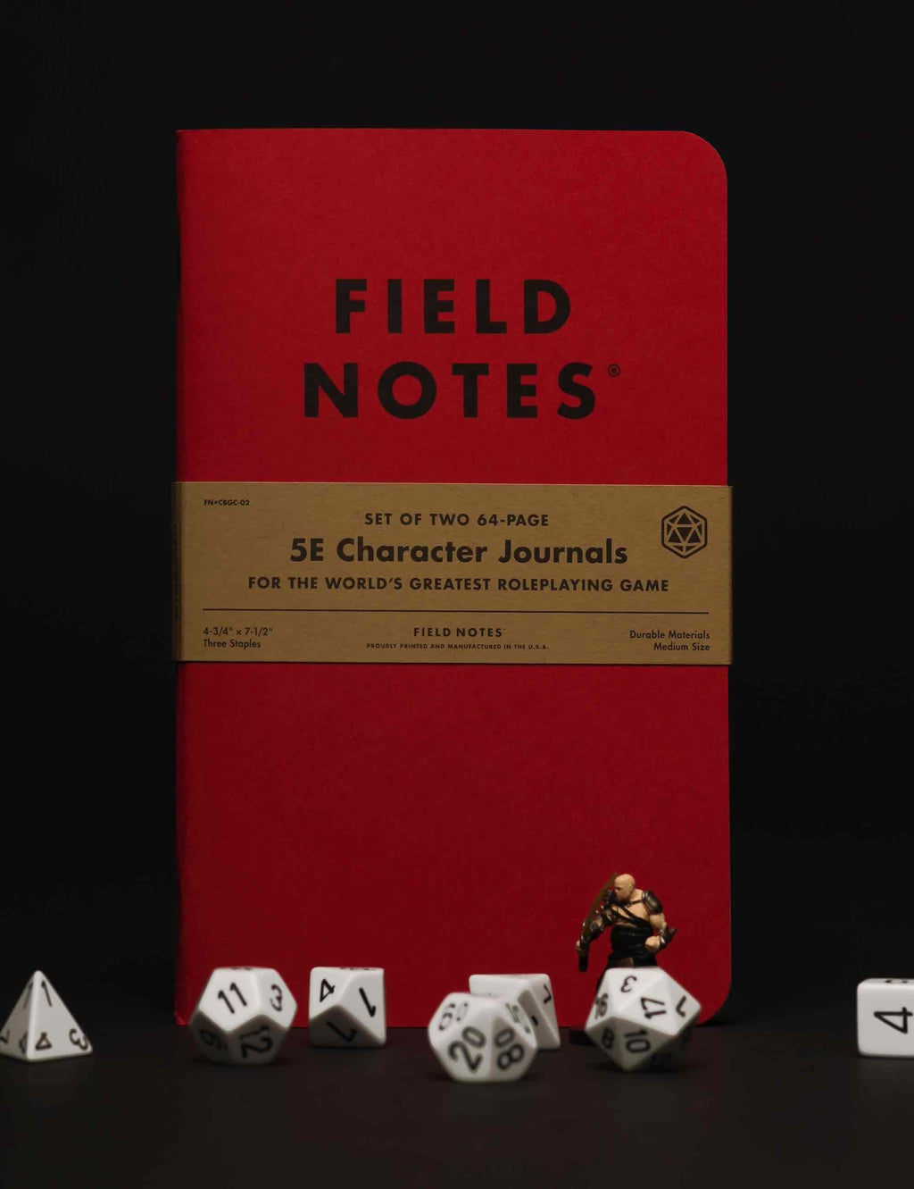 Red Field Notes 5E character journal on tabletop with roleplaying dice