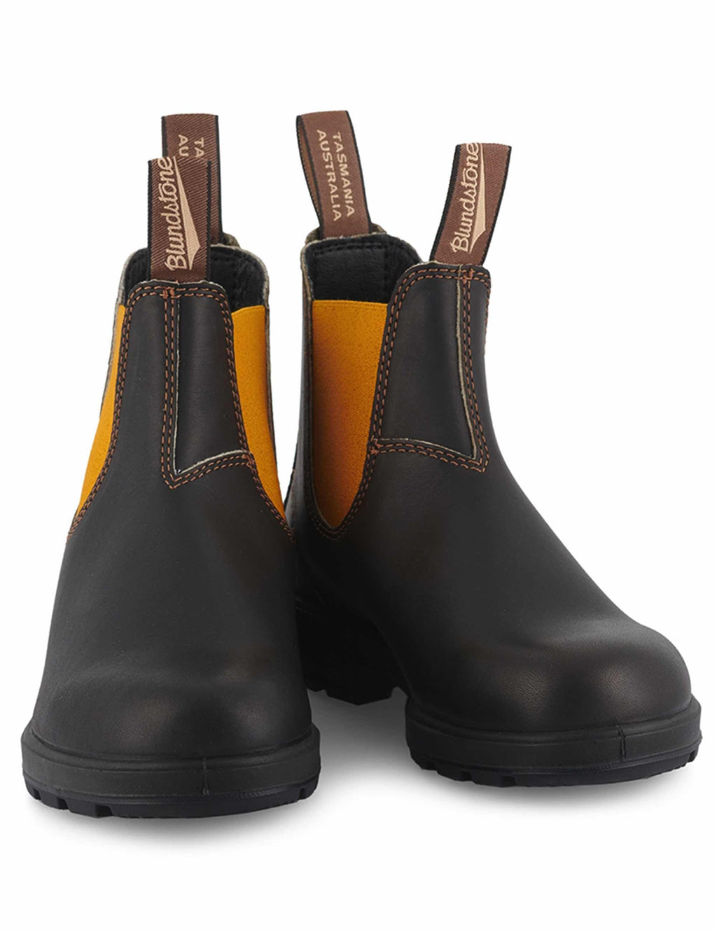 Black leather Chelsea boots with mustard elastic panels, heel pull tabs, and lug sole