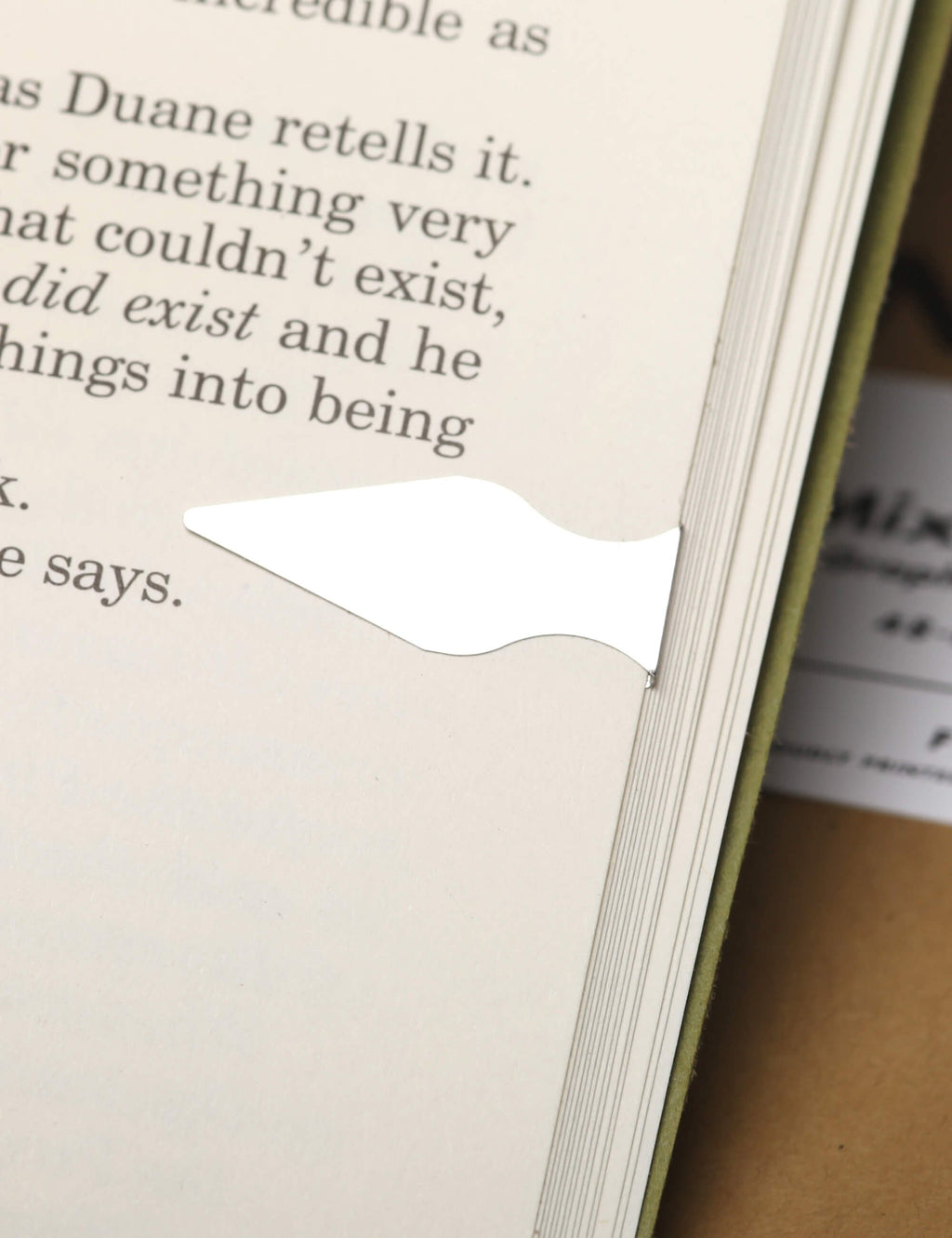Field Notes pages with cutout dart-shaped tab and metal binding edge