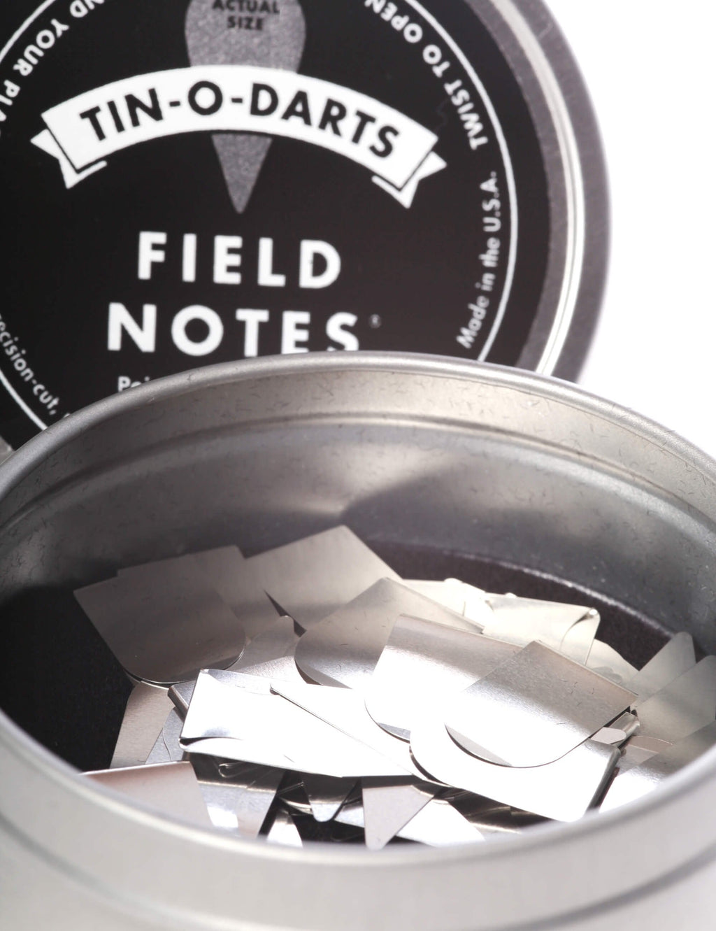 Tin-O-Darts metal tin with open lid and stacked silver dart notes