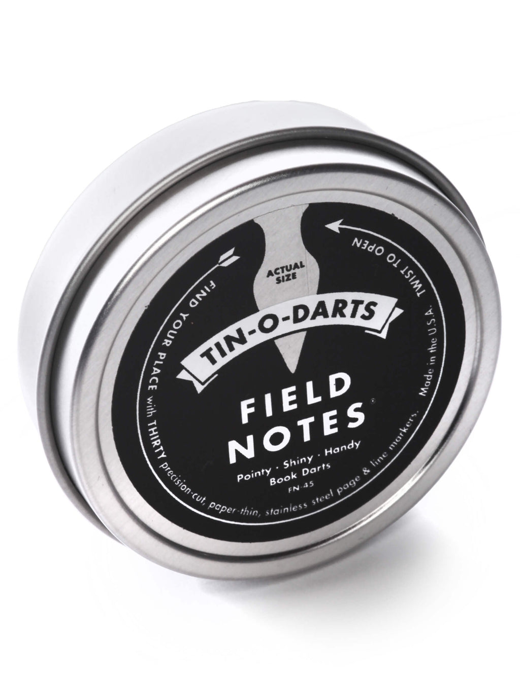Tin-O-Darts metal tin lid labeled "FIELD NOTES", angled view