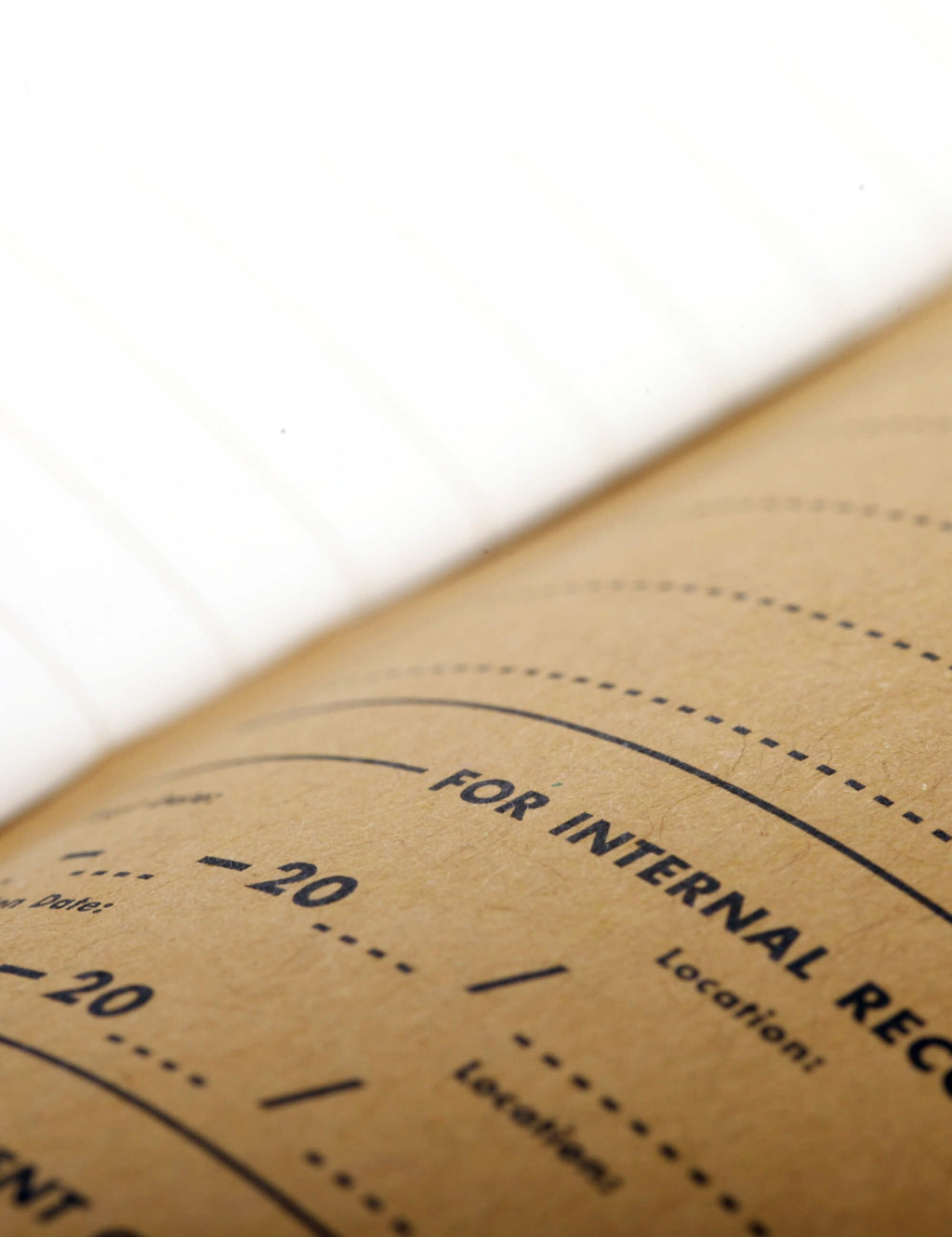 Kraft cover detail with printed 'FOR INTERNAL RE...' circle layout and guide marks.