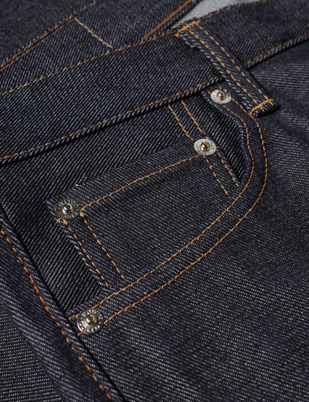 Men's jeans closeup: dark blue pockets with orange contrast stitching and metal rivets