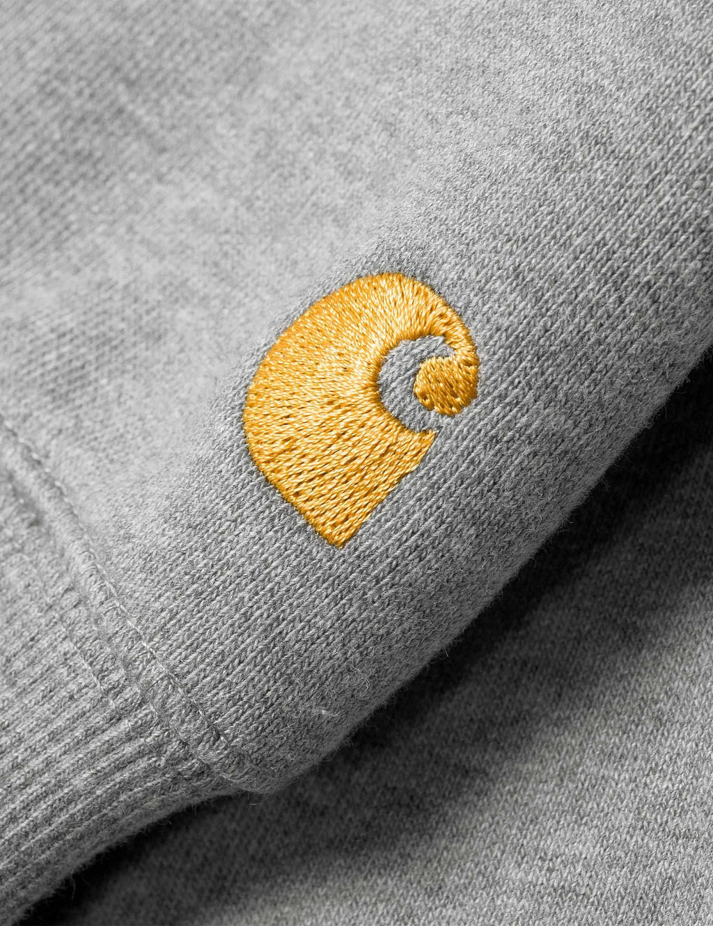 Grey heather sweatshirt sleeve with gold embroidered logo patch