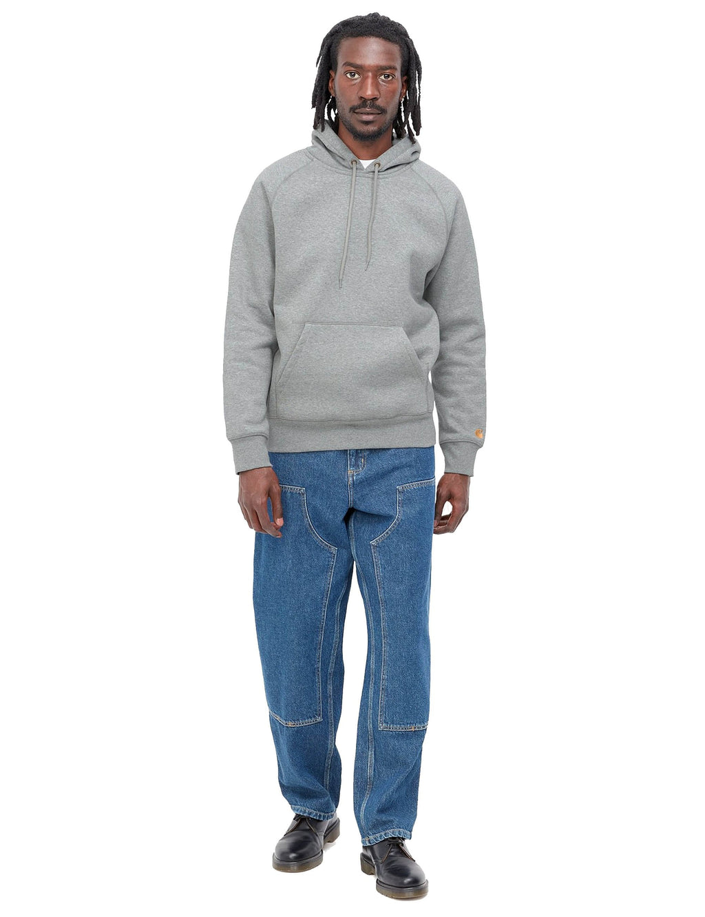 Grey heather hooded sweatshirt on model, gold logo on sleeve cuff