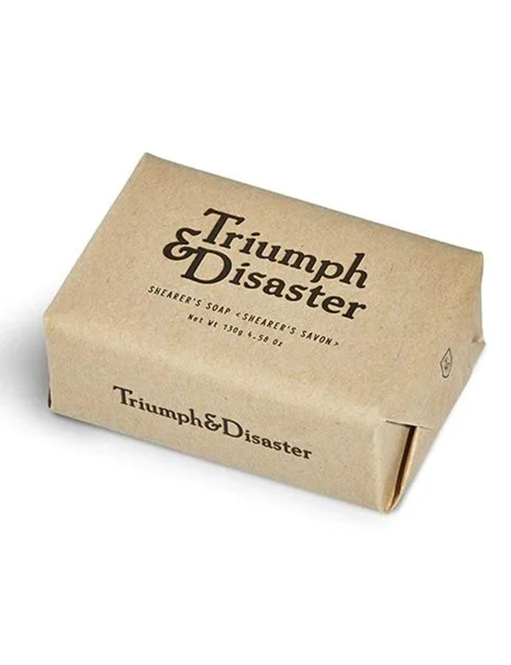 Beige soap bar with 'Triumph & Disaster' label and side logo mark