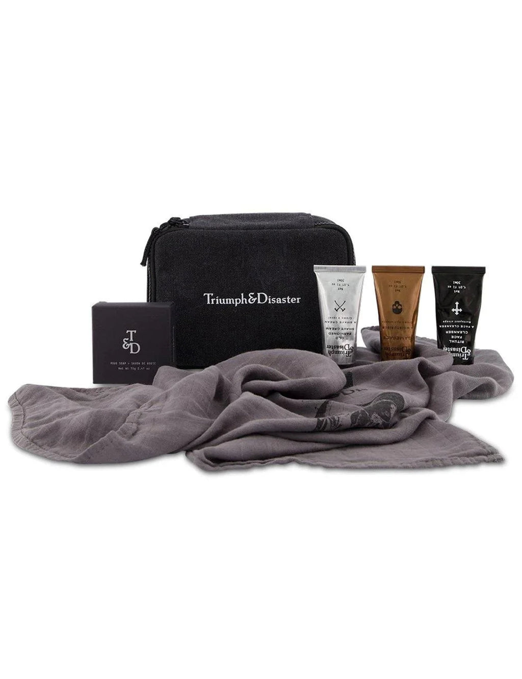 Travel kit with black zip case, gray cloth and multiple skincare tubes and bottles