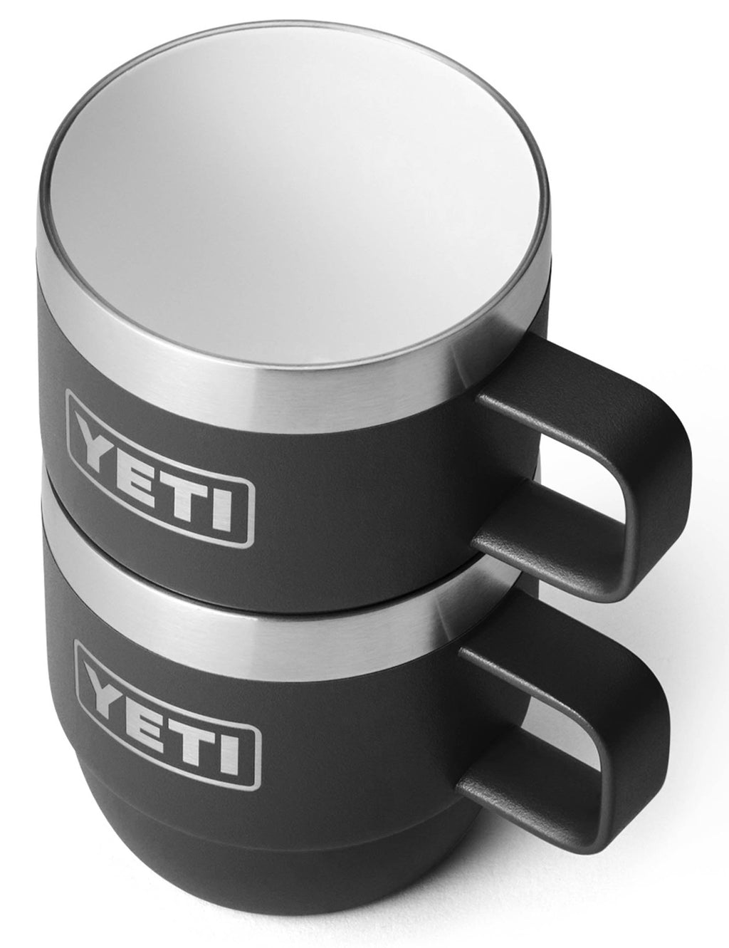 Stacked black espresso mugs with silver rims and YETI logos, with side handles